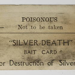 Discoloured bait card with printed black text.