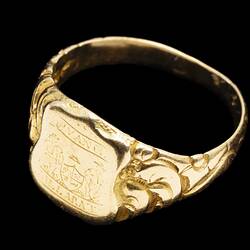 Large gold ring with central shield design featuring the words "Advance Ballaarat" and two miners leaning on a coat of arms.