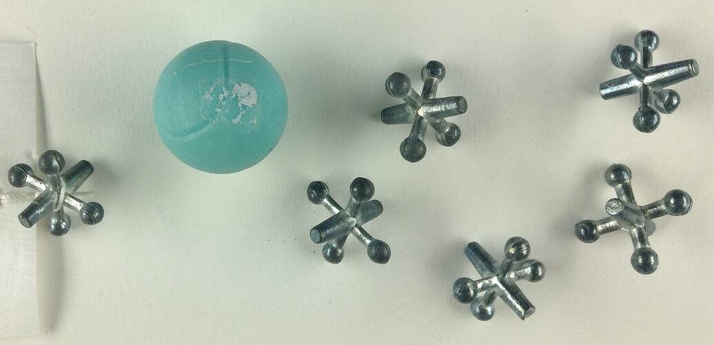 Six silver-coloured metal spiked jacks and blue ball.