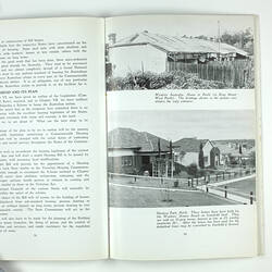 Open booklet with white pages and black printing. Houses on right page.