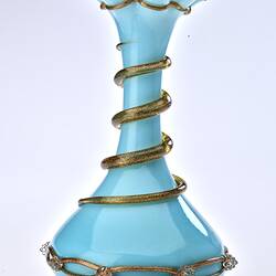 Pale blue opaque glass vase with gilded ribbon spiralling from base up to top. Flared neck with frill at top.