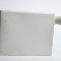 White rectangular ceramic container with cylindrical spout/opening at top right.