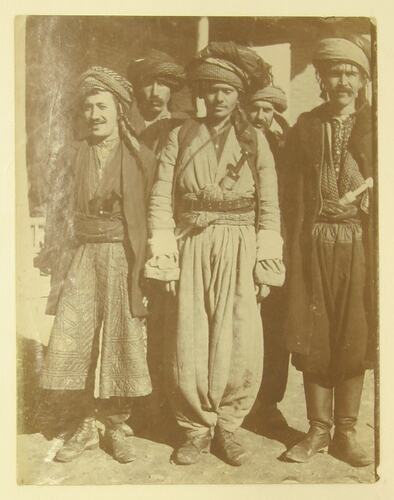 group of Kurdish men in traditional clothing.