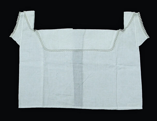 Front view of white chemise, lying flat.