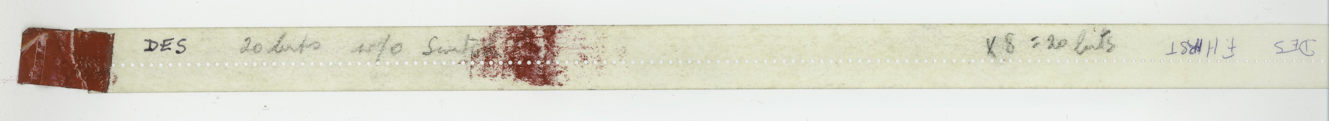 Length of paper tape, text and red marks.