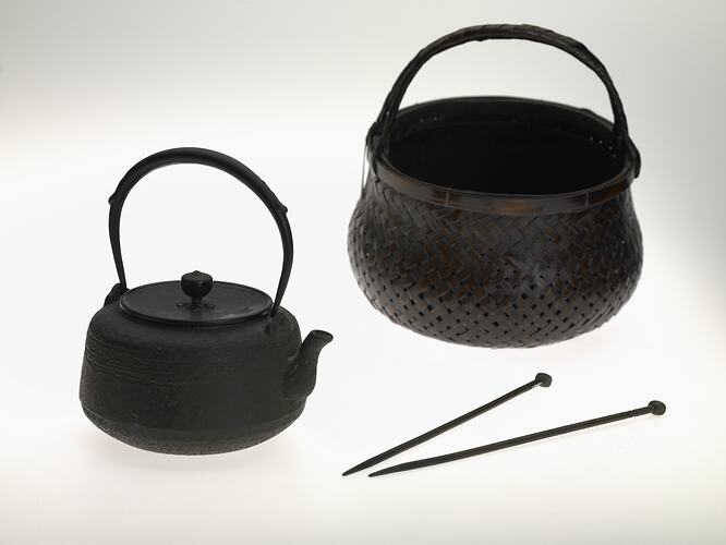 Charcoal tea kettle, pot and sticks.