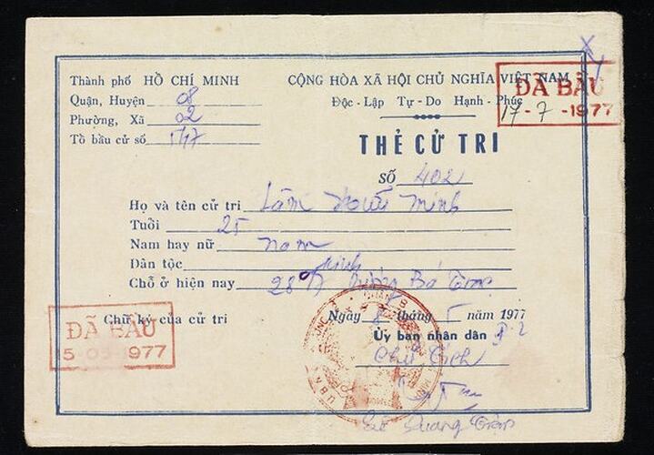 Off white card with blue printing and text. Has three red stamps.