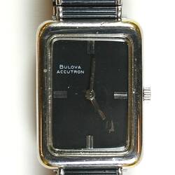 Watch, black and silver rectangular face and flexible band.