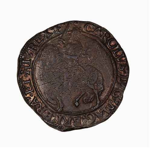Coin, round, at centre within a circle of beads; crowned king wearing long scarf, holding sword near upright.