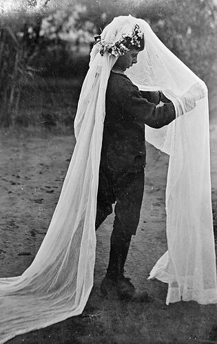 Boy 'dressing up' wearing a bridal veil.
