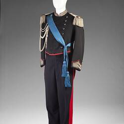 Military uniform with blue shash and feathered hat.