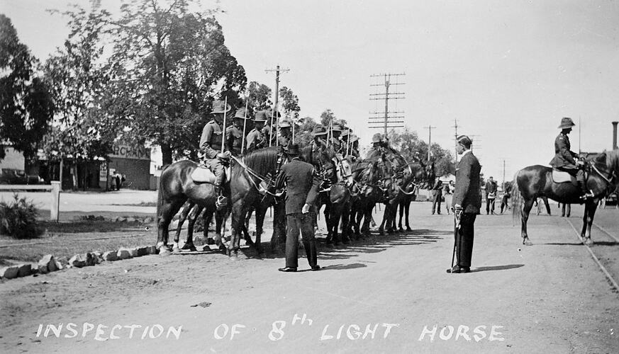 Man inspection soldiers on horses.