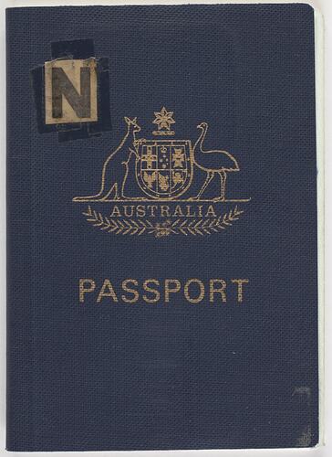Blue passport cover with gold stamped coat of arms and text 'Australia Passport. 'N' in top left corner.