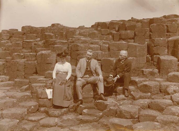 H.V. McKay, Mrs. S. McKay and another man at the Giant's Causeway.