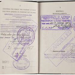 Open passport with white pages. Black printed text and handwriting. Purple Cancelled stamp.