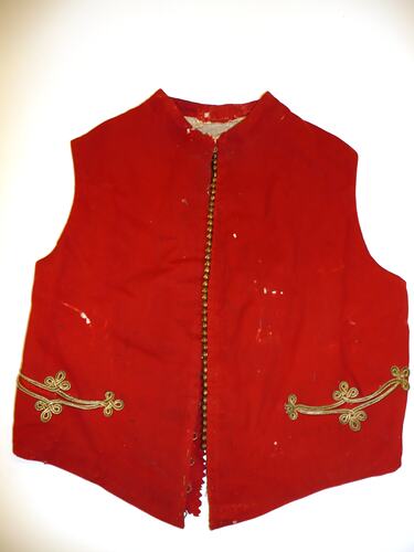 Red waistcoat trimmed with gold braid around pockets and small gilt studs running down left front.