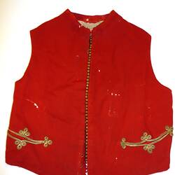 Red waistcoat trimmed with gold braid around pockets and small gilt studs running down left front.