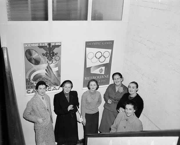 Women Standing in Front of a 1956 Melbourne Olympic Games Promotional Poster, Melbourne, Victoria, 1955-1956