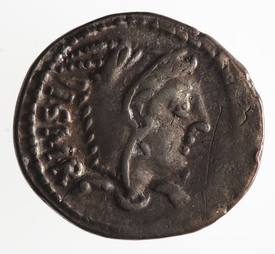 Round coin, aged, female profile facing right, wearing headdress.
