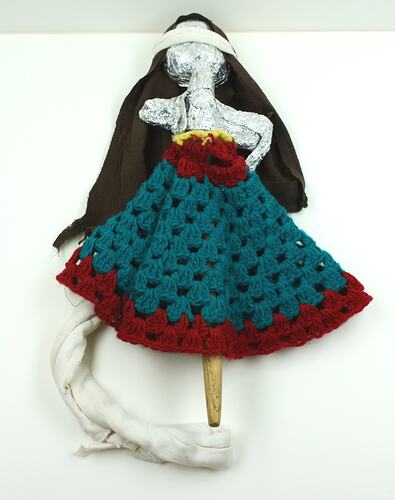 Toy doll made with found materials, front side.