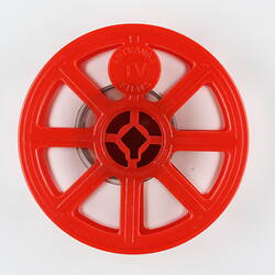 Circular plastic film reel with eight spokes.