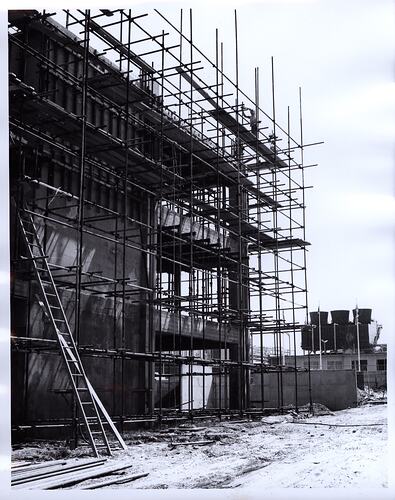 Corner of building construction with scaffolding.
