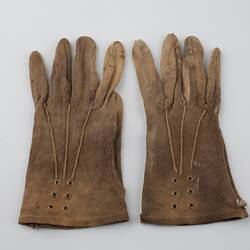 Pair of mid-brown cotton gloves, side by side