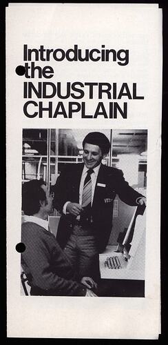 Brochure with image of men speaking in office.