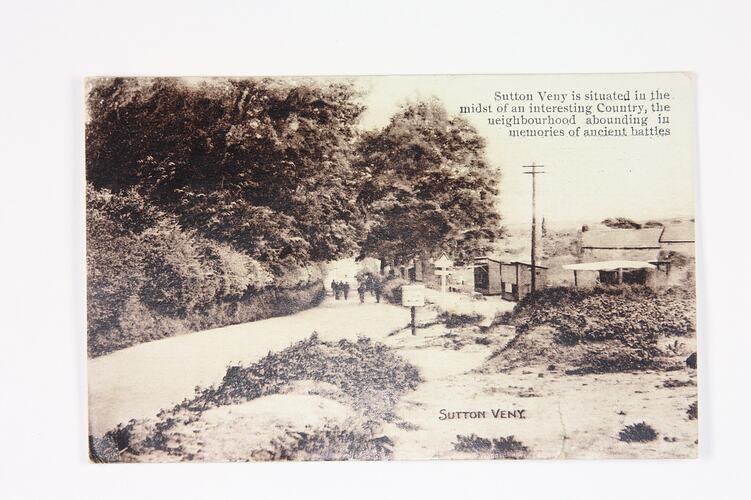 Front of postcard with country scene.