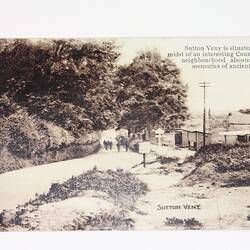 Front of postcard with country scene.