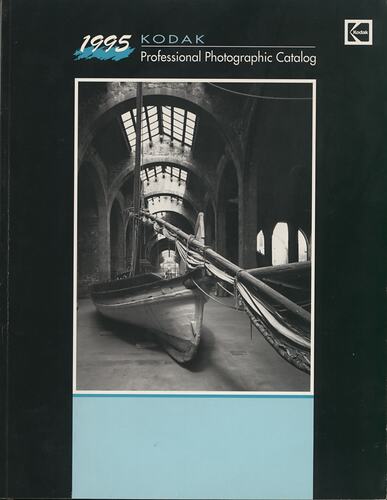 Cover page with photograph of boat in large building.