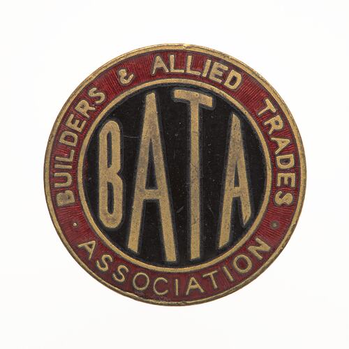 Round badge with blue enamel in centre with gold letters and red around edge.