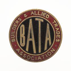 Round badge with blue enamel in centre with gold letters and red around edge.