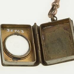 Detail of silver watch chain with silver sovereign case. Open.