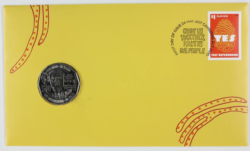 Yellow envelope, red decorative printing. 50 cent silver coin inset left side. Stamp top right corner.