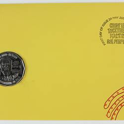 Yellow envelope, red decorative printing. 50 cent silver coin inset left side. Stamp top right corner.