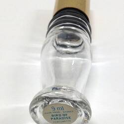 Glass perfume bottle with gold lid, underside.