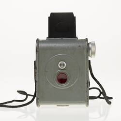 Grey metal camera with silver dial and red button. Rear view.