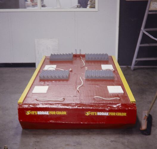 Red raft siting on factory floor.