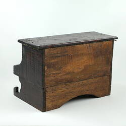 Back of wooden toy piano.