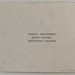 Back of photograph with black printed text.