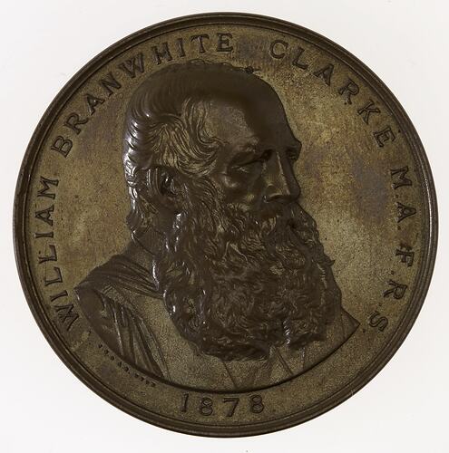 Medal with bust of man with beard, text around.