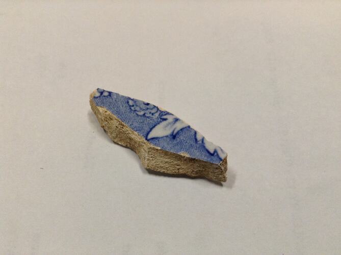 Blue and white ceramic fragment.