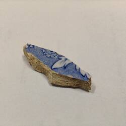 Blue and white ceramic fragment.