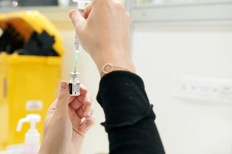 Pharmacist drawing up vaccine, St Vincent's Vaccination Hub, Melbourne Museum, 23 Sep 2021