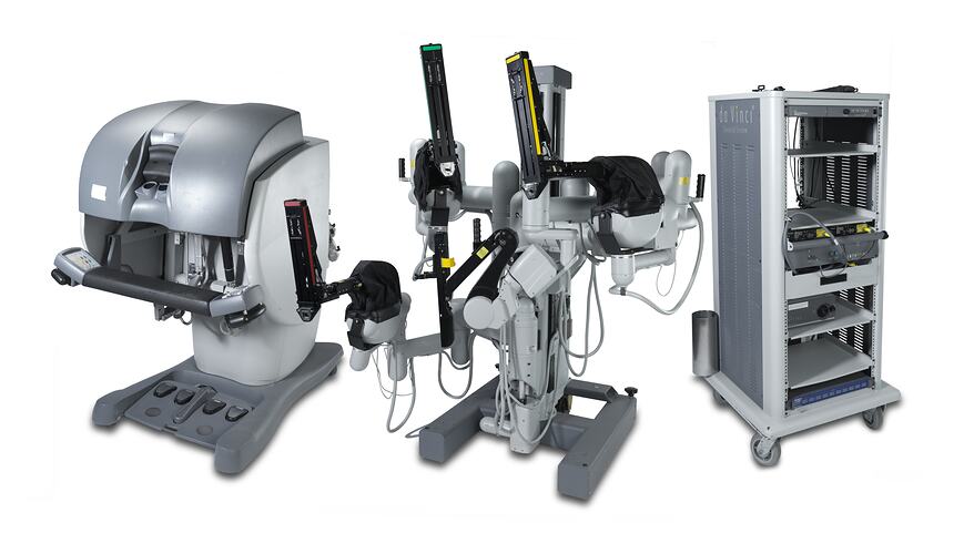 Three parts of a surgical robot. Console with viewer, cart with three arms and cart.