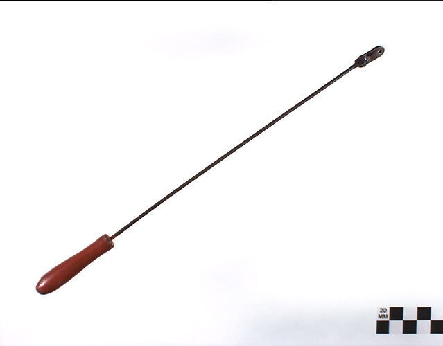Metal rod with red wood handle.