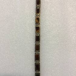 Bracelet made of hand-made silver links, each with tortoiseshell insets. Open.