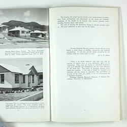 Open booklet with white pages and black printing. Houses on left page.