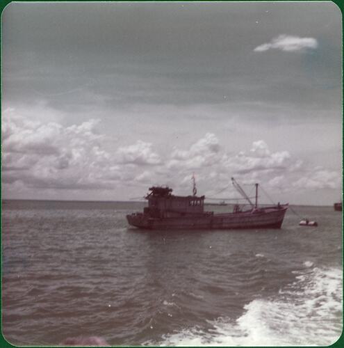 Refugee boat, probably a fishing trawler, at sea.